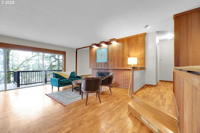 dining room featuring light wood-type flooring and wooden walls