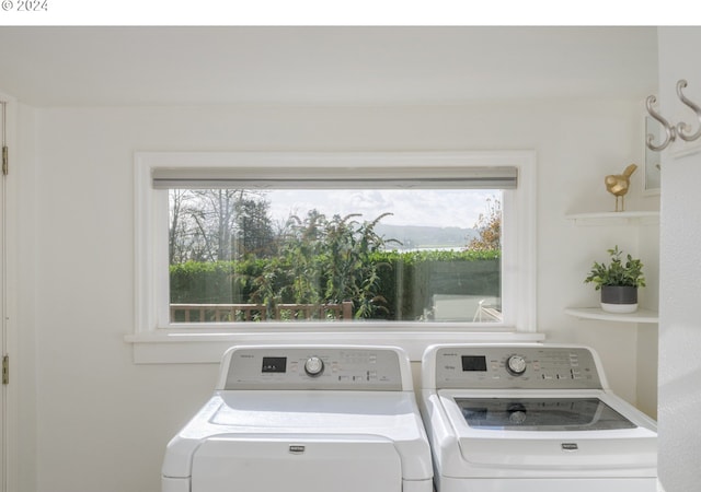 clothes washing area with washing machine and dryer