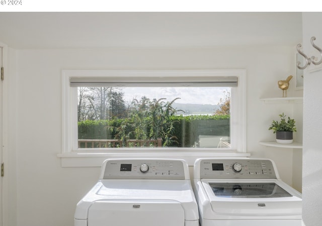 laundry room featuring separate washer and dryer and laundry area
