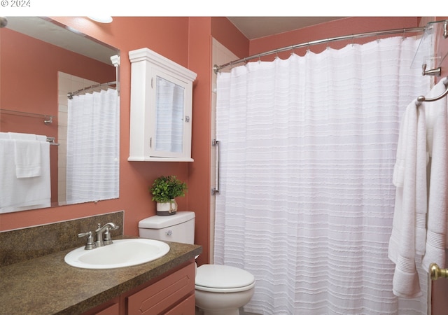 bathroom featuring toilet, a shower with curtain, and vanity