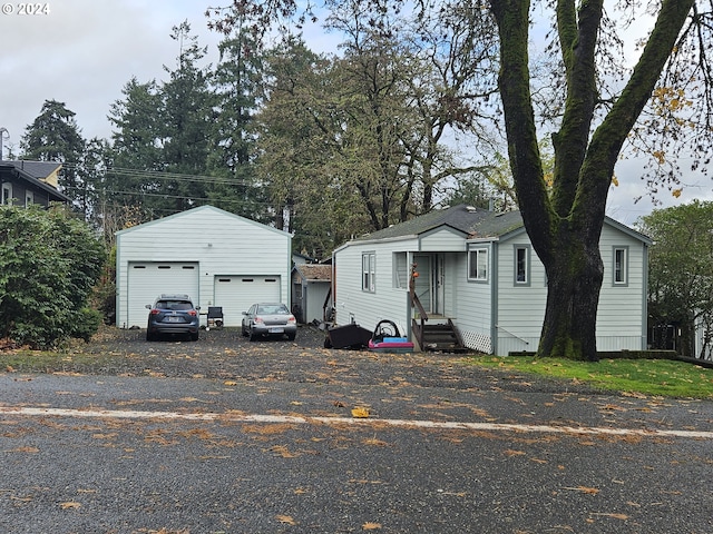 view of front of house with a garage and an outdoor structure