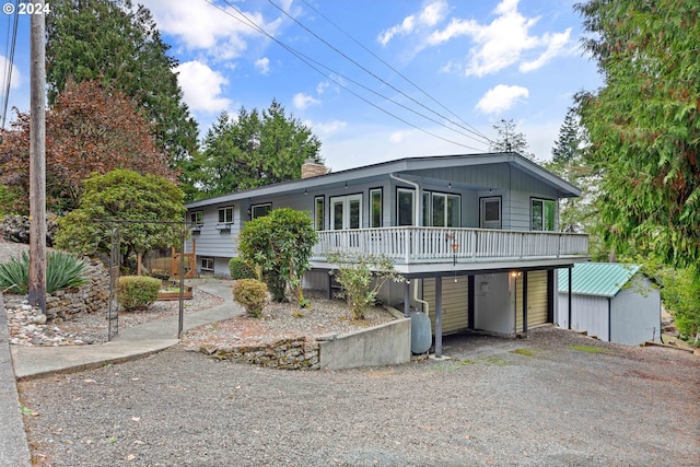 view of front of house featuring a shed and a carport