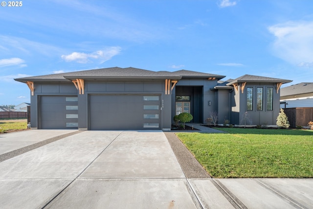 prairie-style house with a garage and a front yard