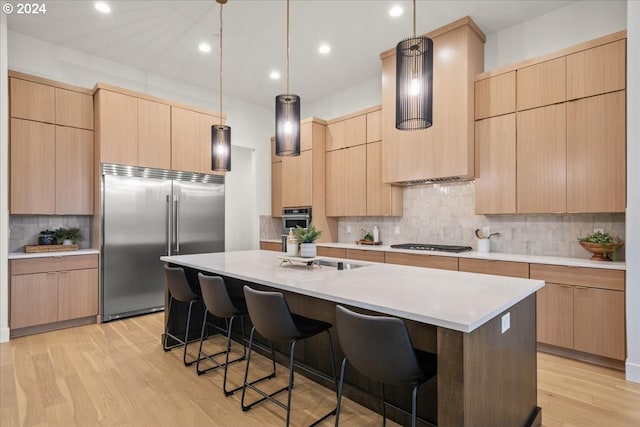 kitchen with appliances with stainless steel finishes and light brown cabinetry