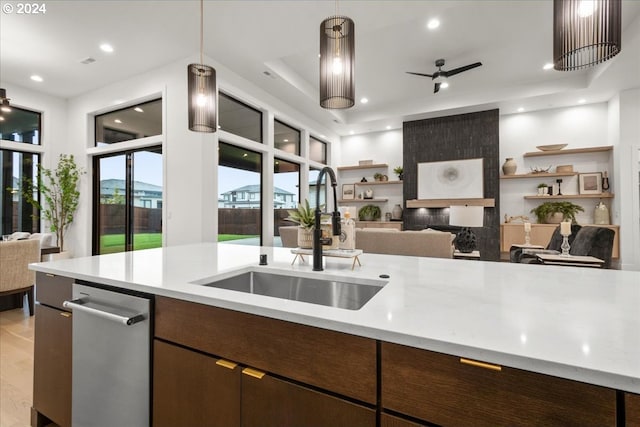 kitchen with sink, ceiling fan, light hardwood / wood-style floors, dark brown cabinetry, and pendant lighting