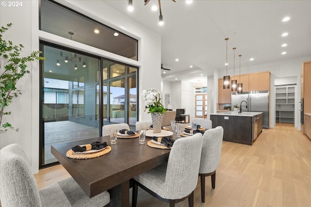 dining space with light hardwood / wood-style floors