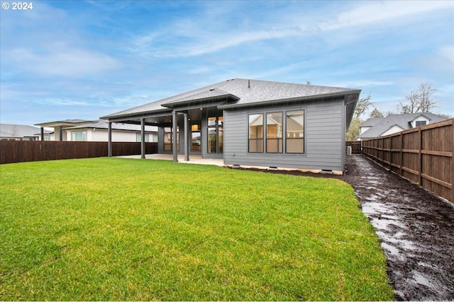 back of property featuring a yard and a patio