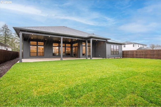 rear view of property featuring a patio area and a yard