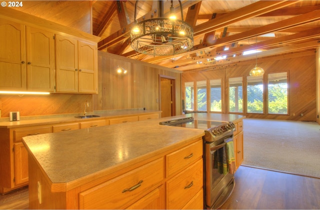 kitchen featuring stainless steel electric range oven, a kitchen island, lofted ceiling with beams, and wooden ceiling