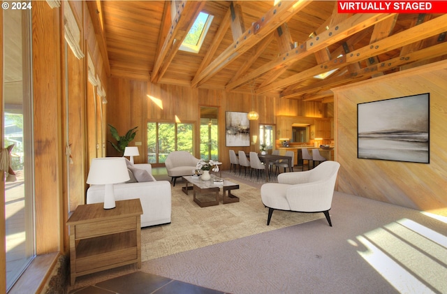 carpeted living room with a skylight, wood ceiling, wooden walls, high vaulted ceiling, and beamed ceiling