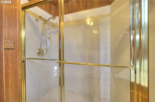 bathroom featuring a shower with shower door