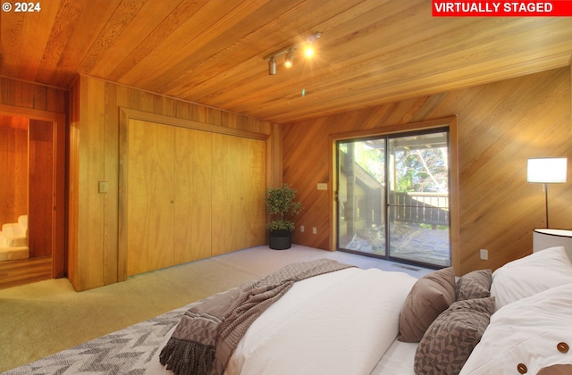 bedroom with wood walls, access to exterior, wood ceiling, and light carpet