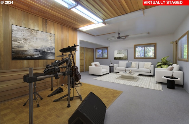 workout room featuring wood walls and ceiling fan