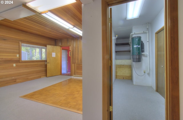 corridor featuring wooden walls