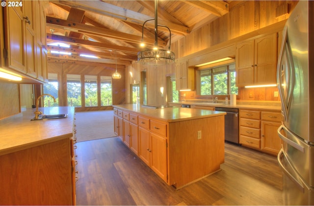 kitchen with appliances with stainless steel finishes, wood ceiling, vaulted ceiling with beams, a kitchen island, and hanging light fixtures