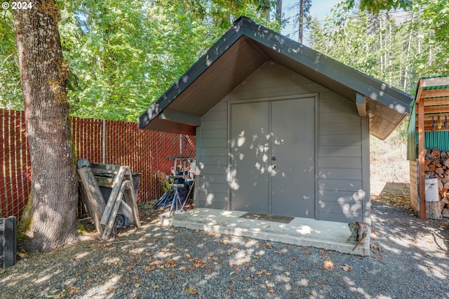 view of shed featuring fence