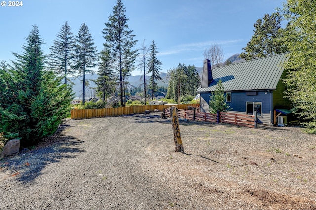 view of street featuring gravel driveway and a mountain view