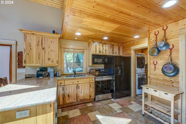 kitchen with stacked washer and clothes dryer, light countertops, wood ceiling, a sink, and black appliances