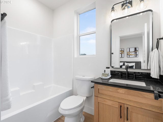 full bathroom featuring vanity, hardwood / wood-style flooring, toilet, and tub / shower combination