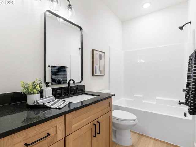 full bathroom with shower / tub combination, toilet, vanity, and hardwood / wood-style flooring