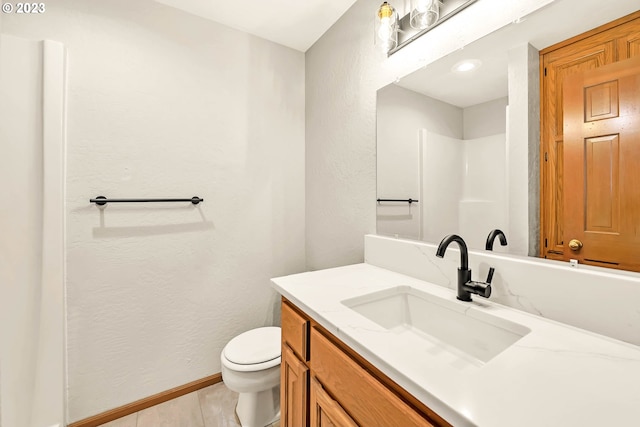 bathroom with vanity, toilet, and tile patterned floors