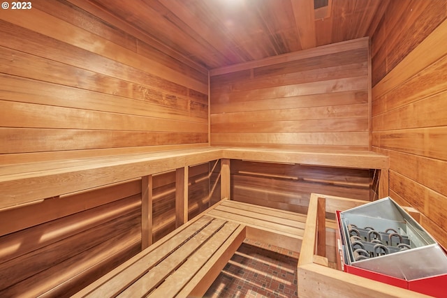 view of sauna with wood ceiling and wood walls