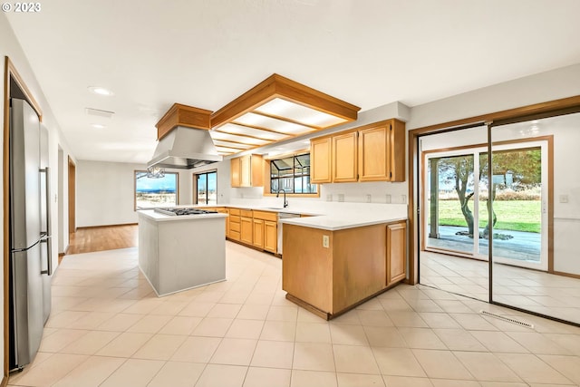 27717 Royal Ave, Eugene, OR 97402 - kitchen featuring stainless steel appliances, exhaust hood, light countertops, a sink, and a peninsula