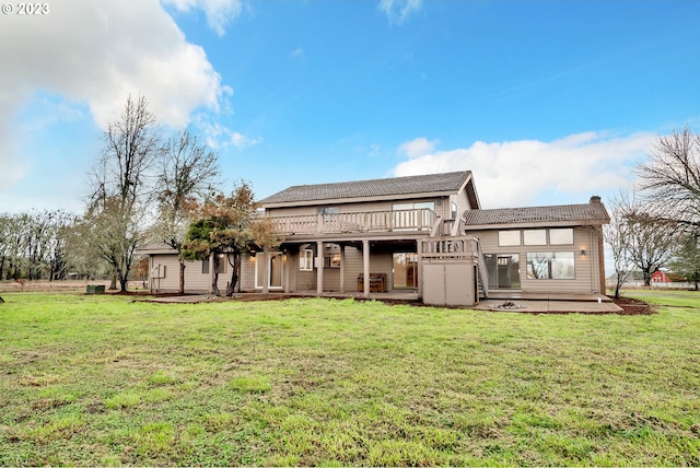 back of house with a yard and a deck