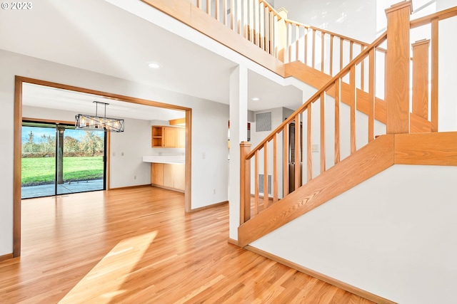 27717 Royal Ave, Eugene, OR 97402 - stairs with a chandelier, wood finished floors, baseboards, and recessed lighting