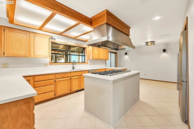 kitchen with light brown cabinets, island exhaust hood, light tile patterned floors, stainless steel appliances, and sink