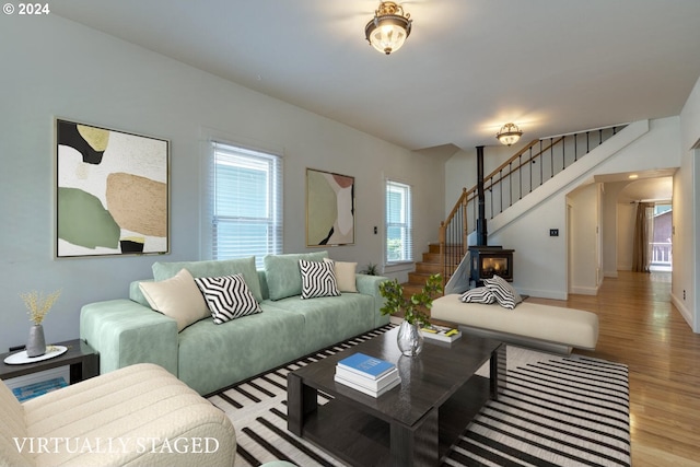 living room featuring hardwood / wood-style floors and a wood stove