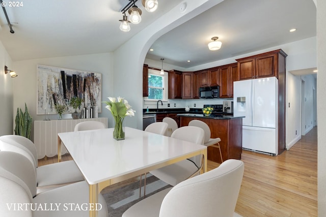 dining area featuring light hardwood / wood-style floors and sink