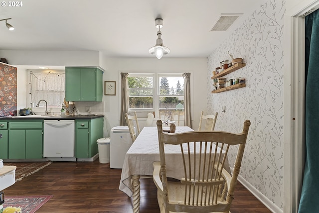 dining space featuring dark hardwood / wood-style flooring and sink