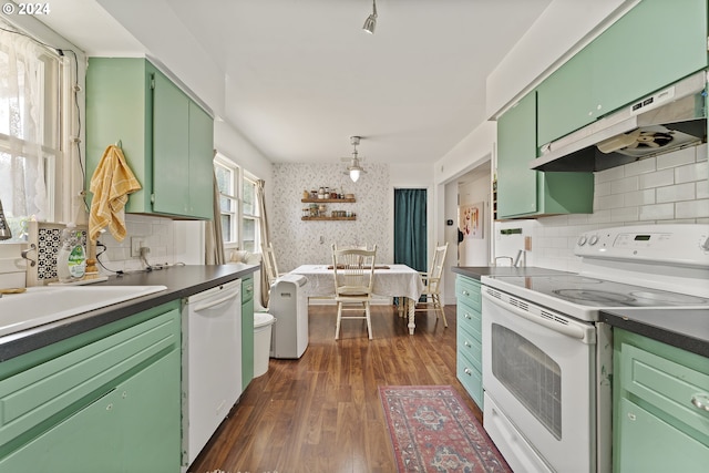 kitchen featuring white appliances, backsplash, green cabinets, dark hardwood / wood-style flooring, and extractor fan