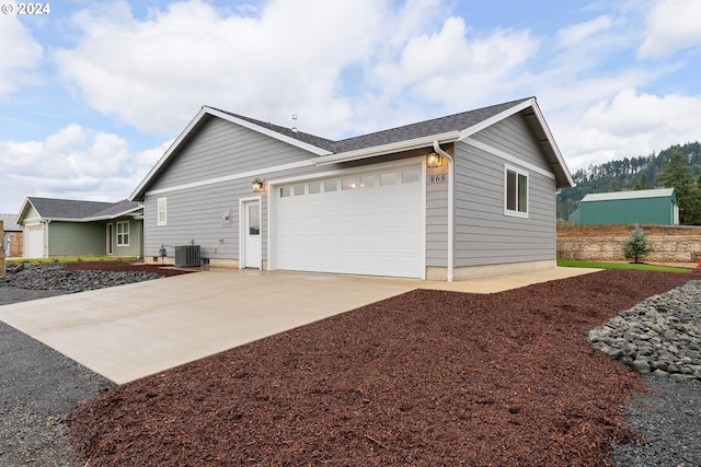 view of home's exterior with central AC and a garage