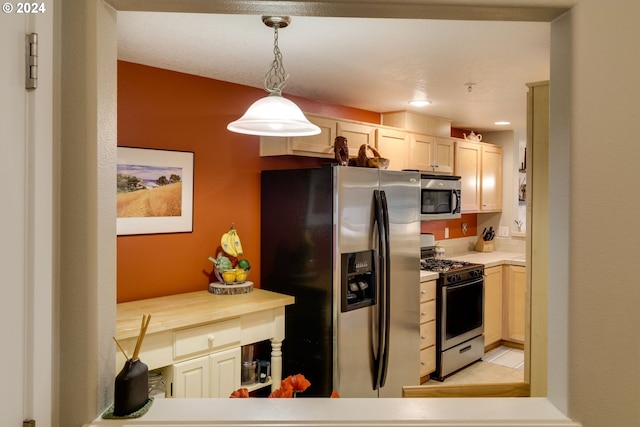 kitchen featuring pendant lighting and stainless steel appliances