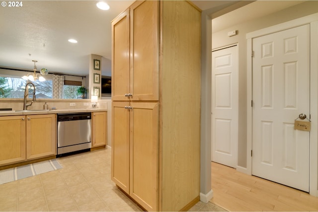 kitchen with light brown cabinetry, an inviting chandelier, stainless steel dishwasher, and sink