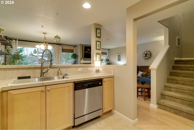 kitchen featuring sink, dishwasher, light brown cabinets, a notable chandelier, and backsplash