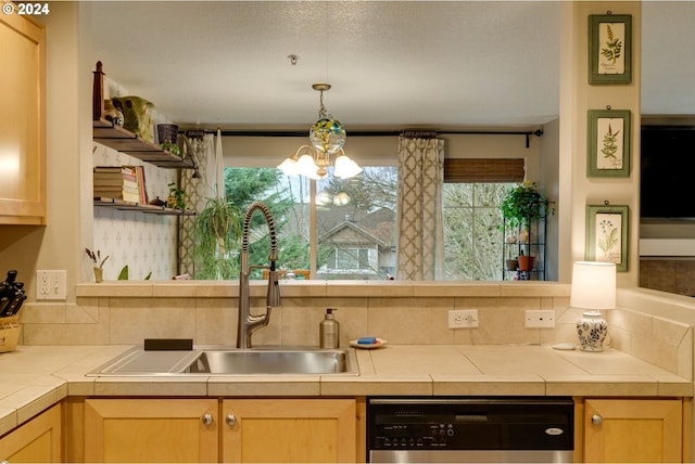 kitchen with dishwasher, light brown cabinets, sink, tile countertops, and a chandelier