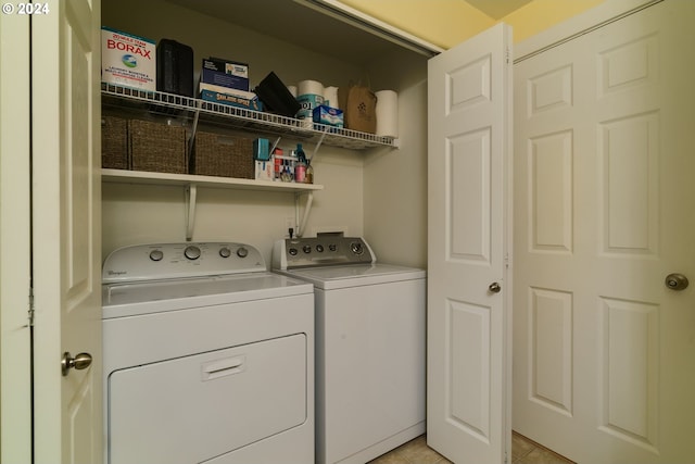 laundry area featuring washing machine and dryer and light tile patterned floors