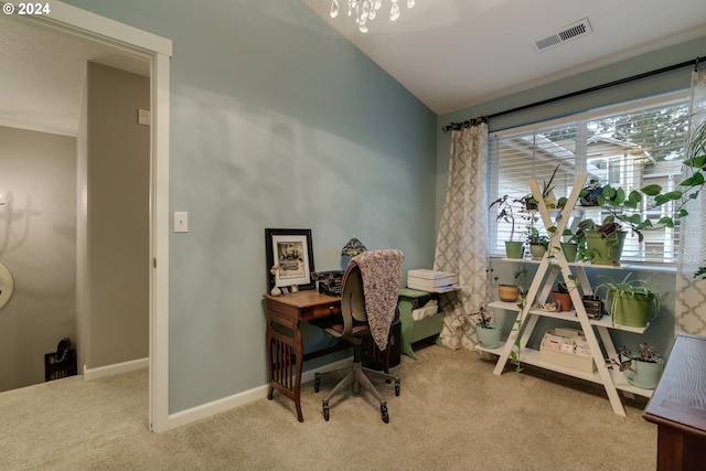 carpeted home office with a chandelier and vaulted ceiling