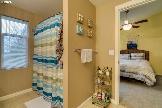 bathroom featuring ceiling fan, tile patterned flooring, and a shower with shower curtain