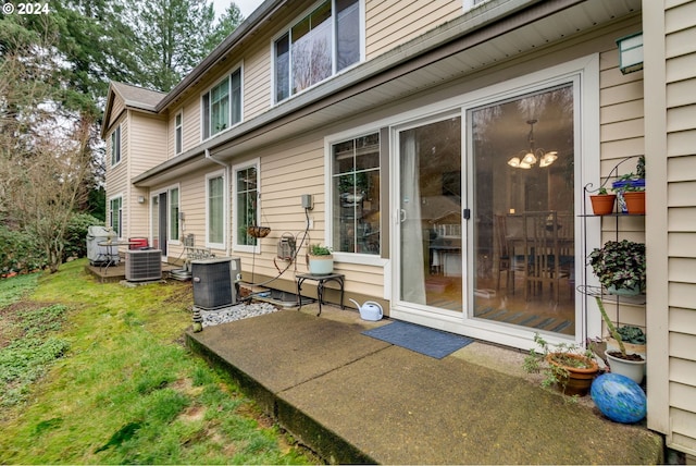 back of house with a yard, a patio, and central AC