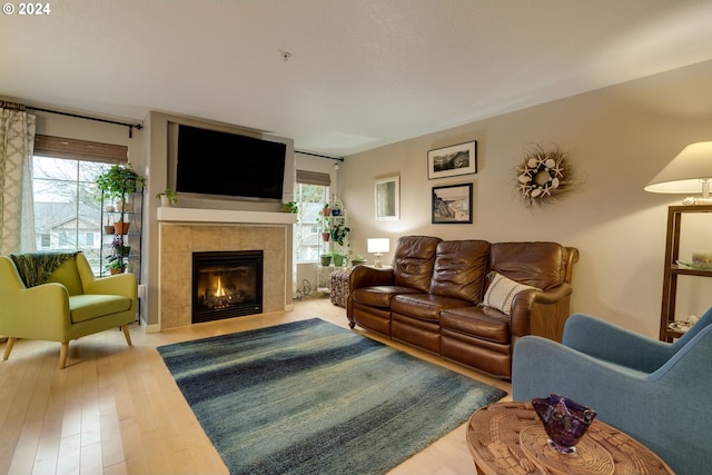 living room featuring hardwood / wood-style floors and a tile fireplace