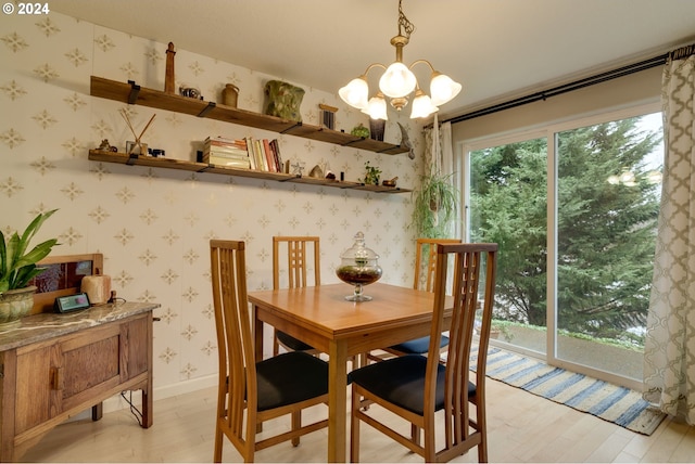 dining area featuring a notable chandelier and light hardwood / wood-style flooring