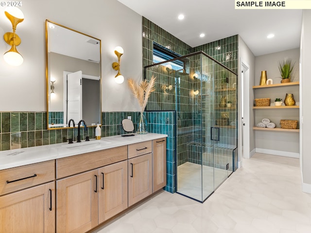 bathroom with tile walls, recessed lighting, a stall shower, and vanity