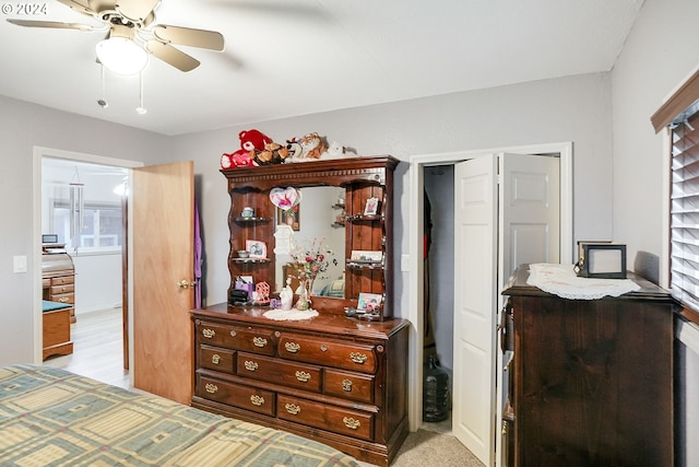 bedroom featuring ceiling fan and light colored carpet