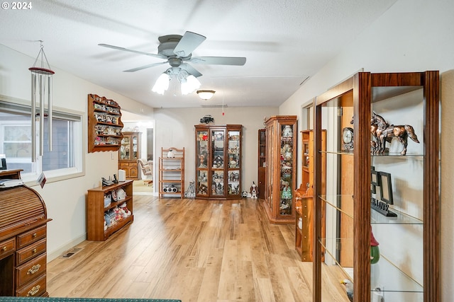 interior space with a textured ceiling and light wood-type flooring