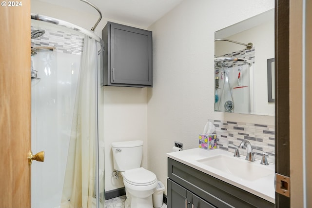 bathroom with vanity, toilet, backsplash, and walk in shower