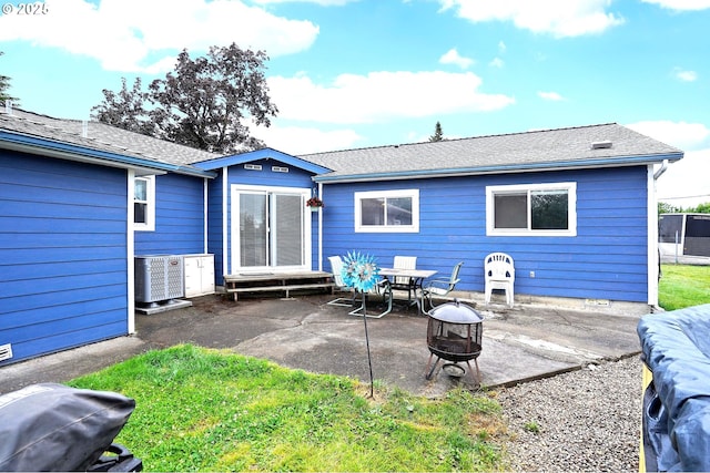 4837 Auburn Rd NE, Salem, OR 97301 - back of house featuring a fire pit, a patio, central AC, and entry steps